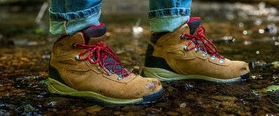 A close-up shot of a hiker’s feet standing on a scenic trail in a pair of Columbia Sportswear hiking boots.